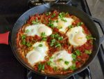 Traditional shashuka, eggs poached in tomato sauce