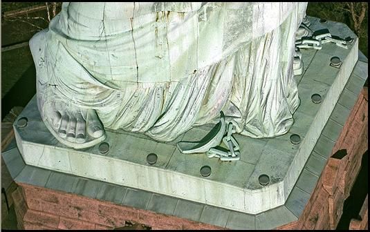 Broken shackles at the feet of the Statue of Liberty