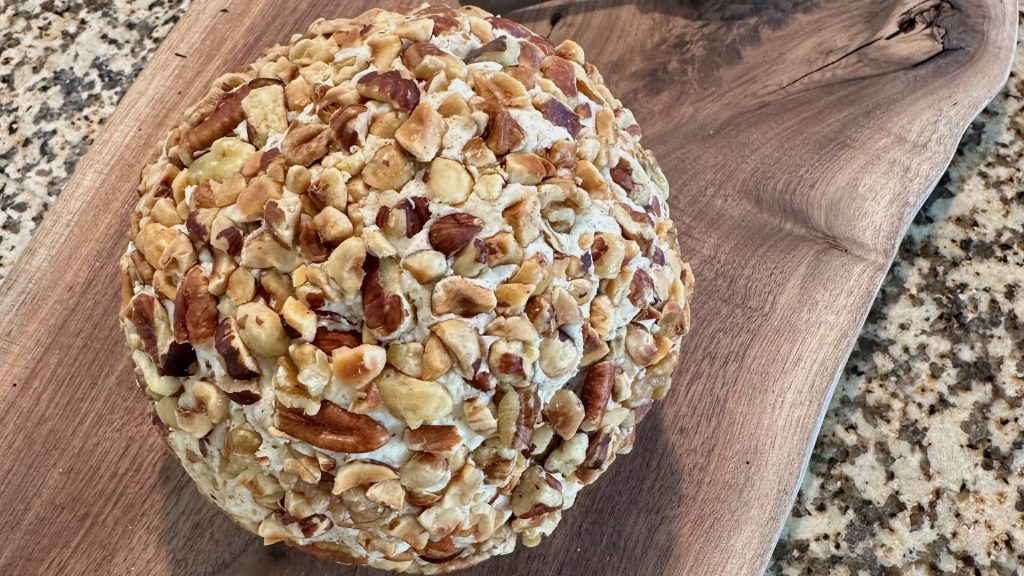 Cheese ball appetizer covered in chopped nuts