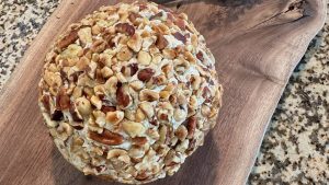 Cheese ball appetizer covered in chopped nuts