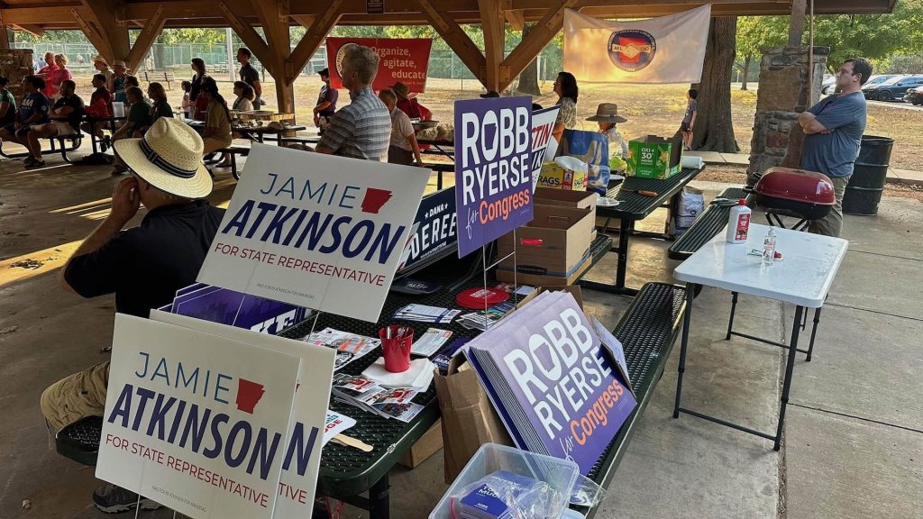 The "merch table" of free campaign materials of candidates attending the 2026 Labor Day Labor Picnic, Sept. 7, at Veterans Memorial Park in Fayetteville.