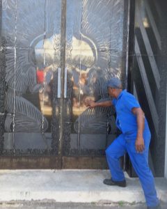A worker points out a feature of a mausoleum at Cementerio de Cristóbal Colón (Christopher Columbus) in Havana.