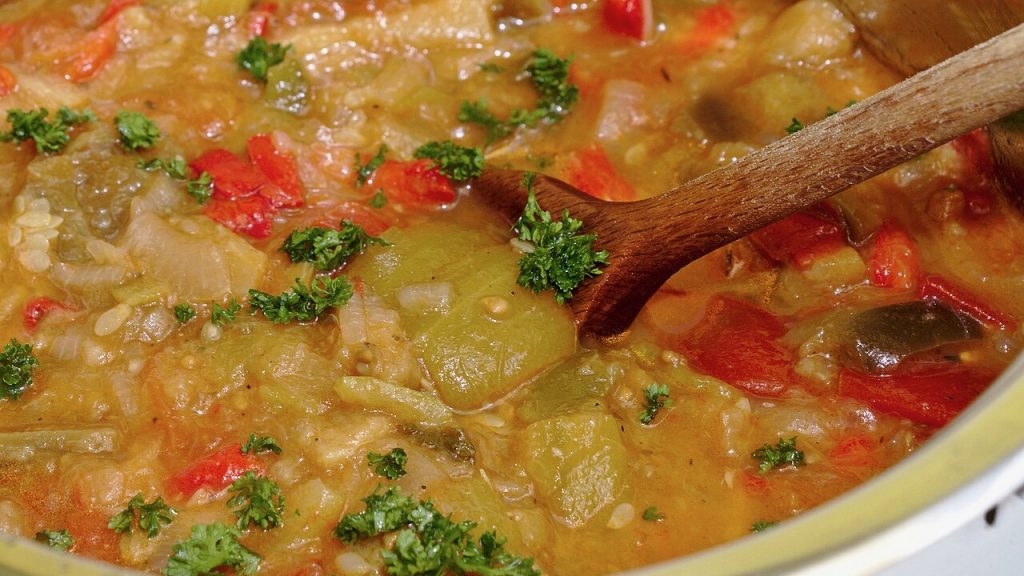 Ratatouille in a pot, heavily simmered and garnished with fresh parsley